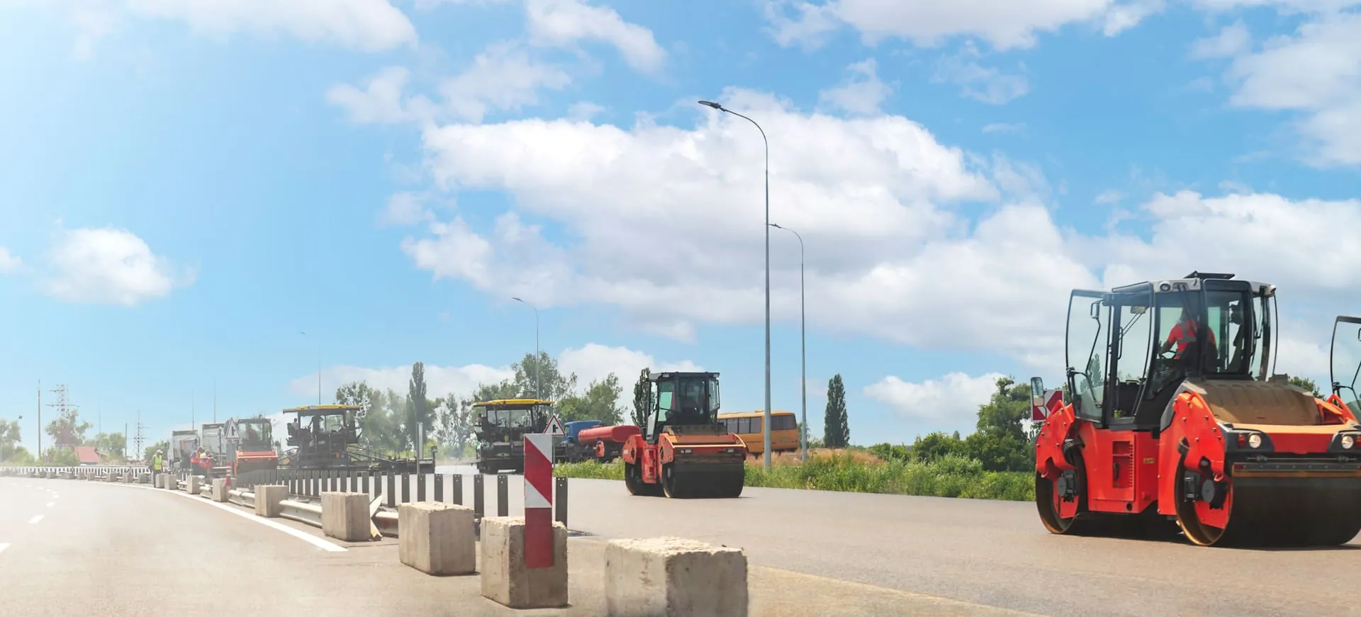 Road repair crew and equipment working on a road