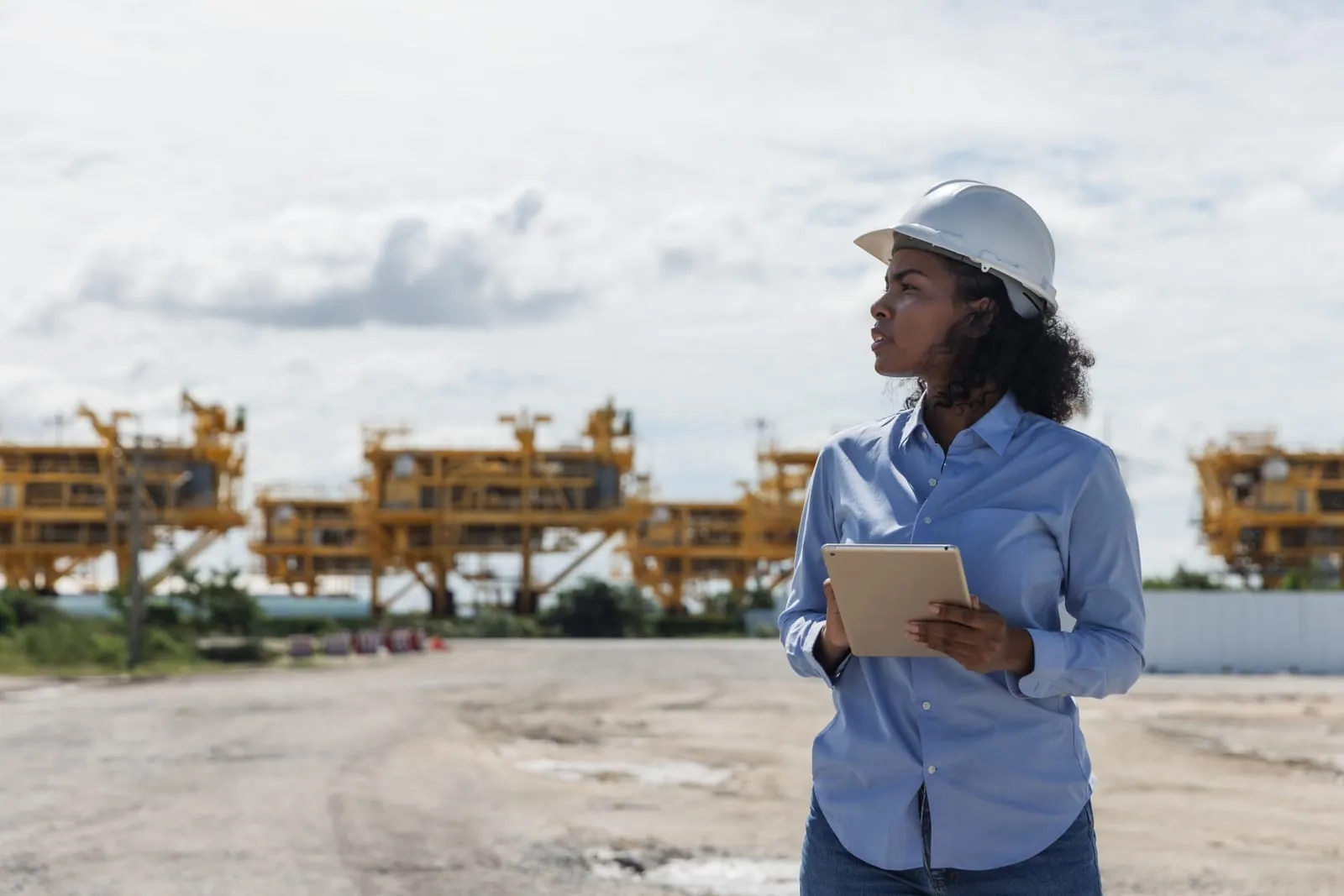 Site engineer reviewing the operation on a tablet at a Ghana site