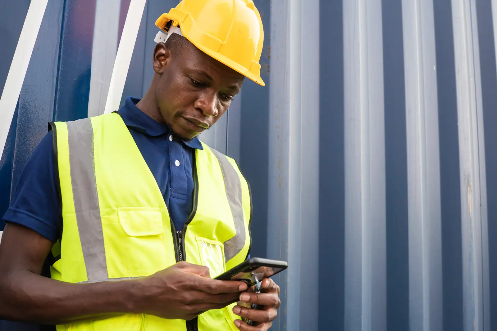 Worker logging an event on a phone on site