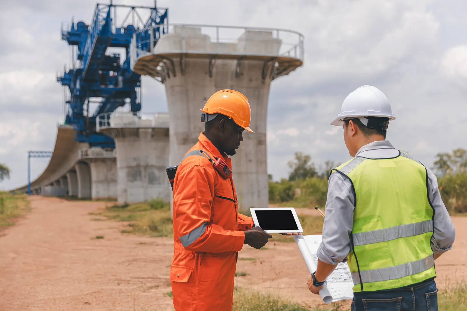 Engineer with a tablet beneath a bridge launching gantry