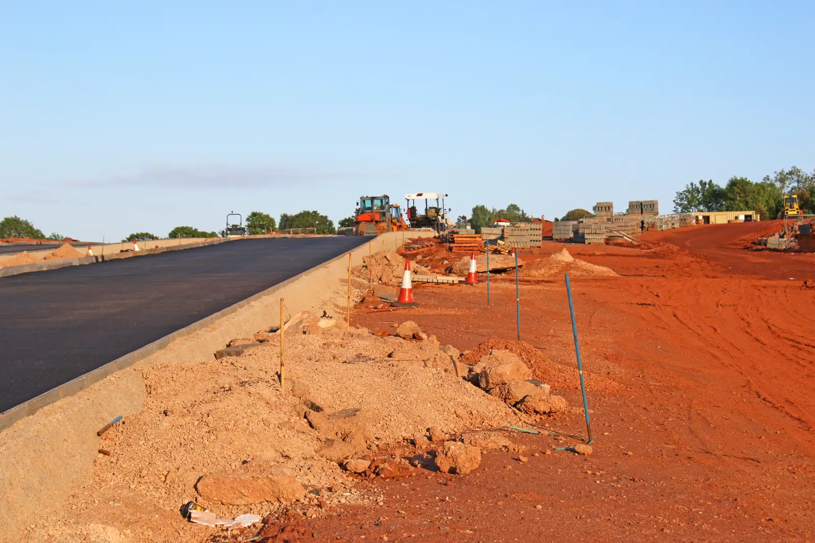 Fresh asphalt laid along a red-earth formation