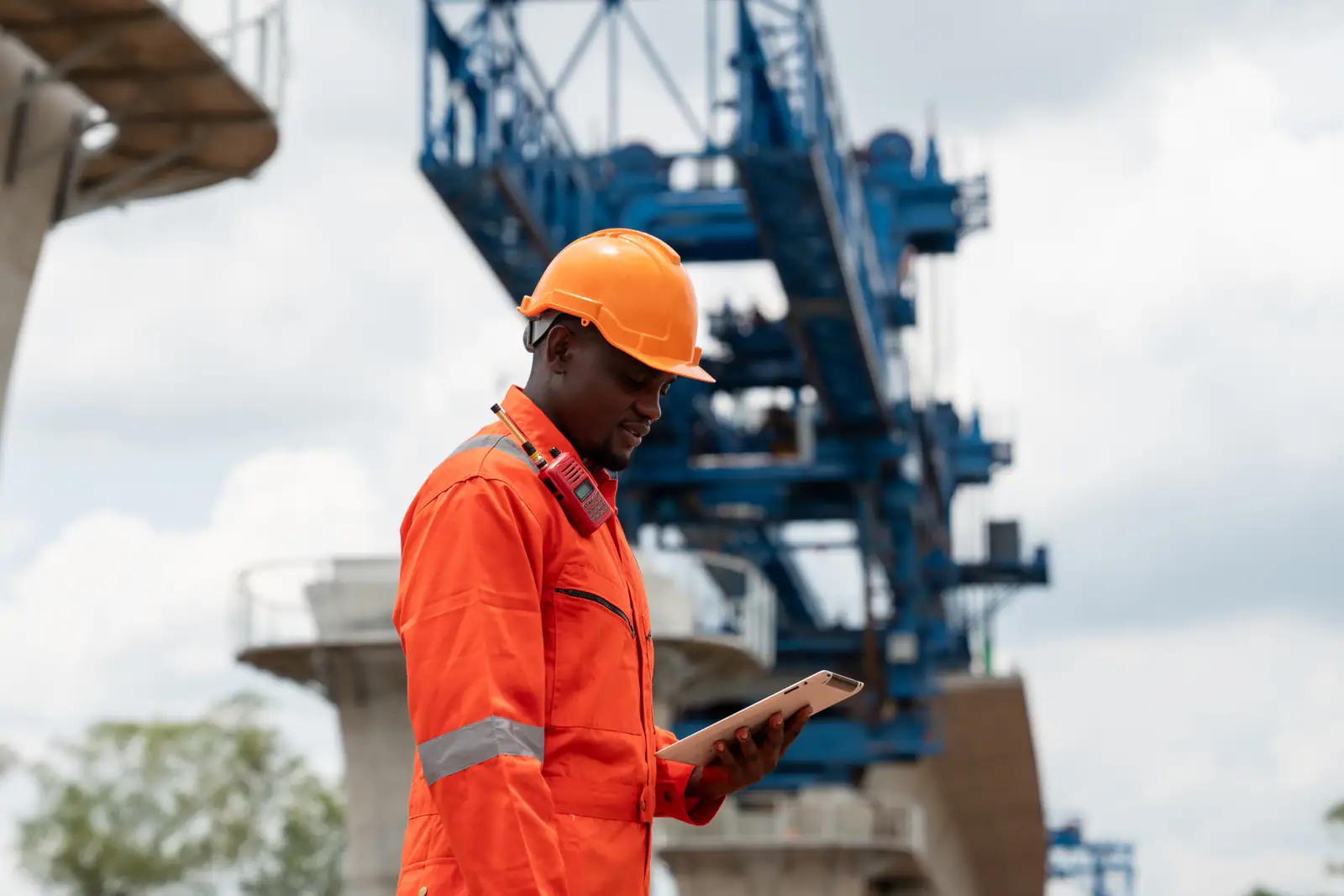 Engineer with a tablet beneath a bridge launching gantry