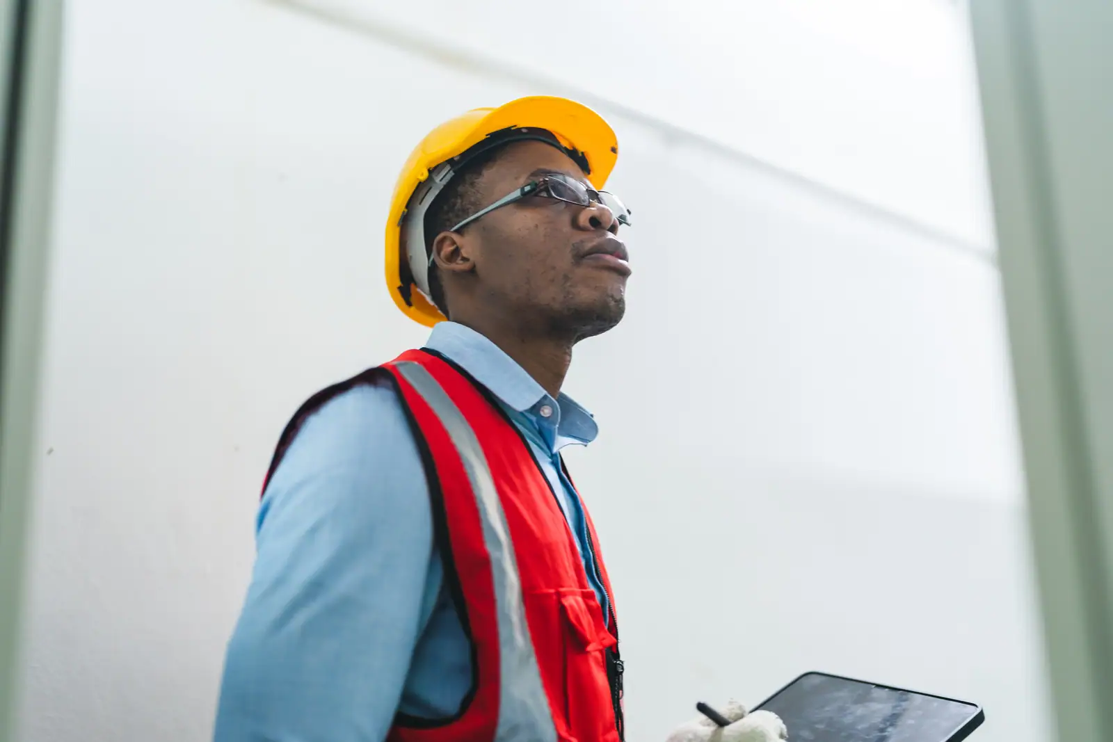 Engineer with a tablet inspecting progress inside a new build