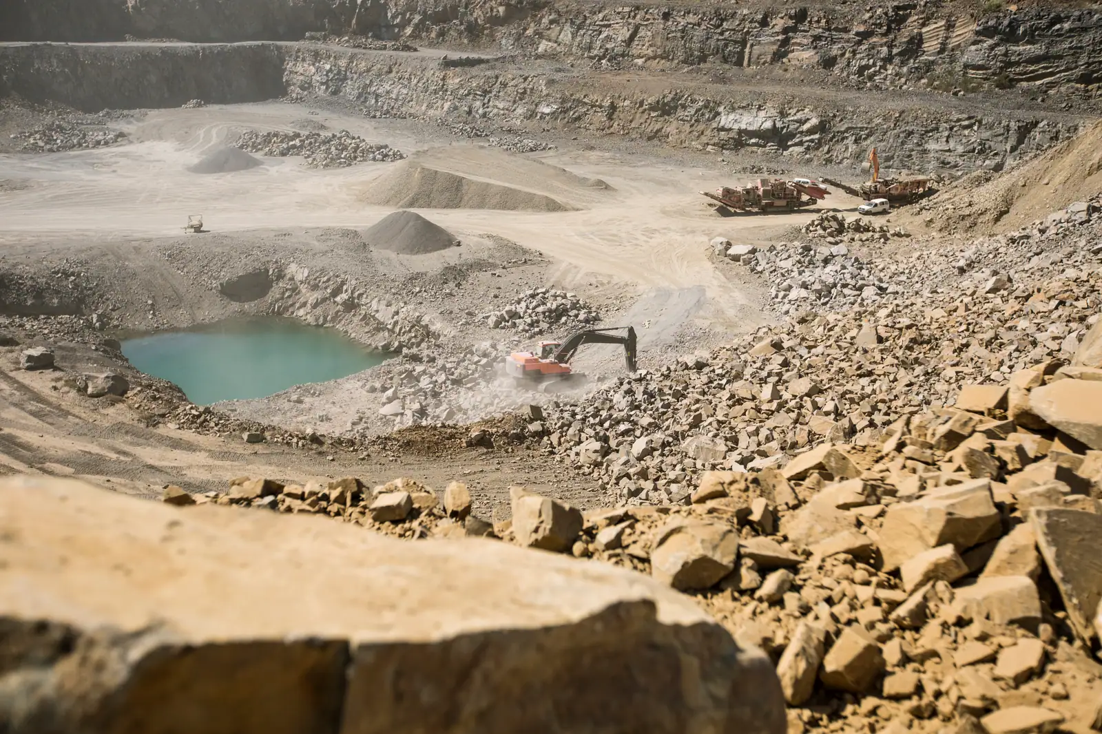 Excavator working a rock quarry in Ghana