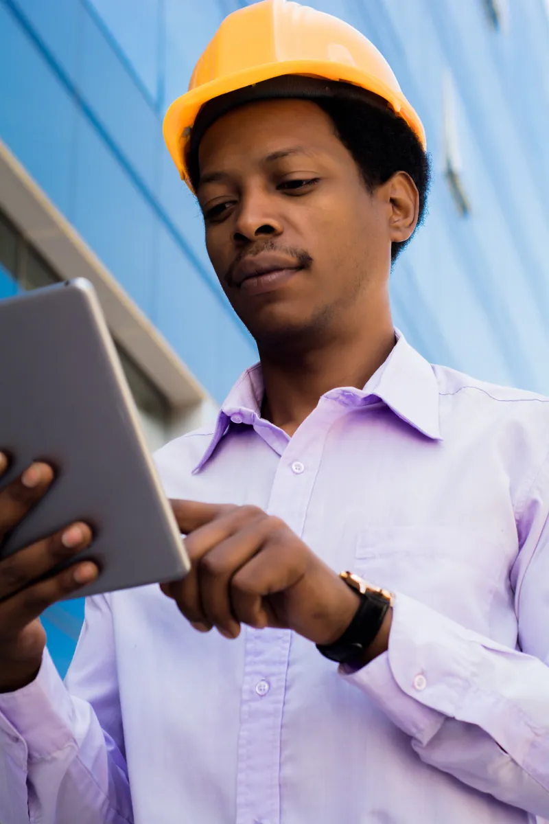 Site worker capturing an event on a rugged tablet on a Ghana site