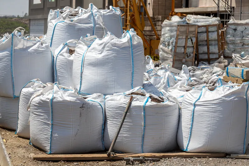 Bagged construction material staged on a project site