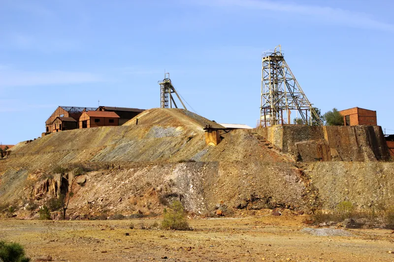 Open-pit gold working face with excavator loading in Ghana