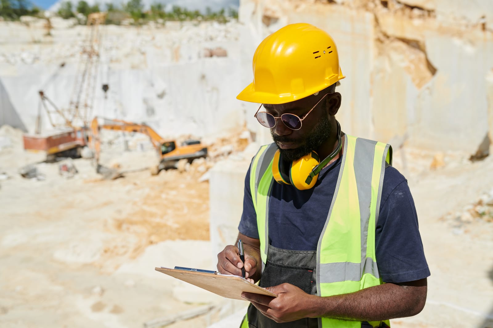 Mining contractor reviewing operational data on tablet